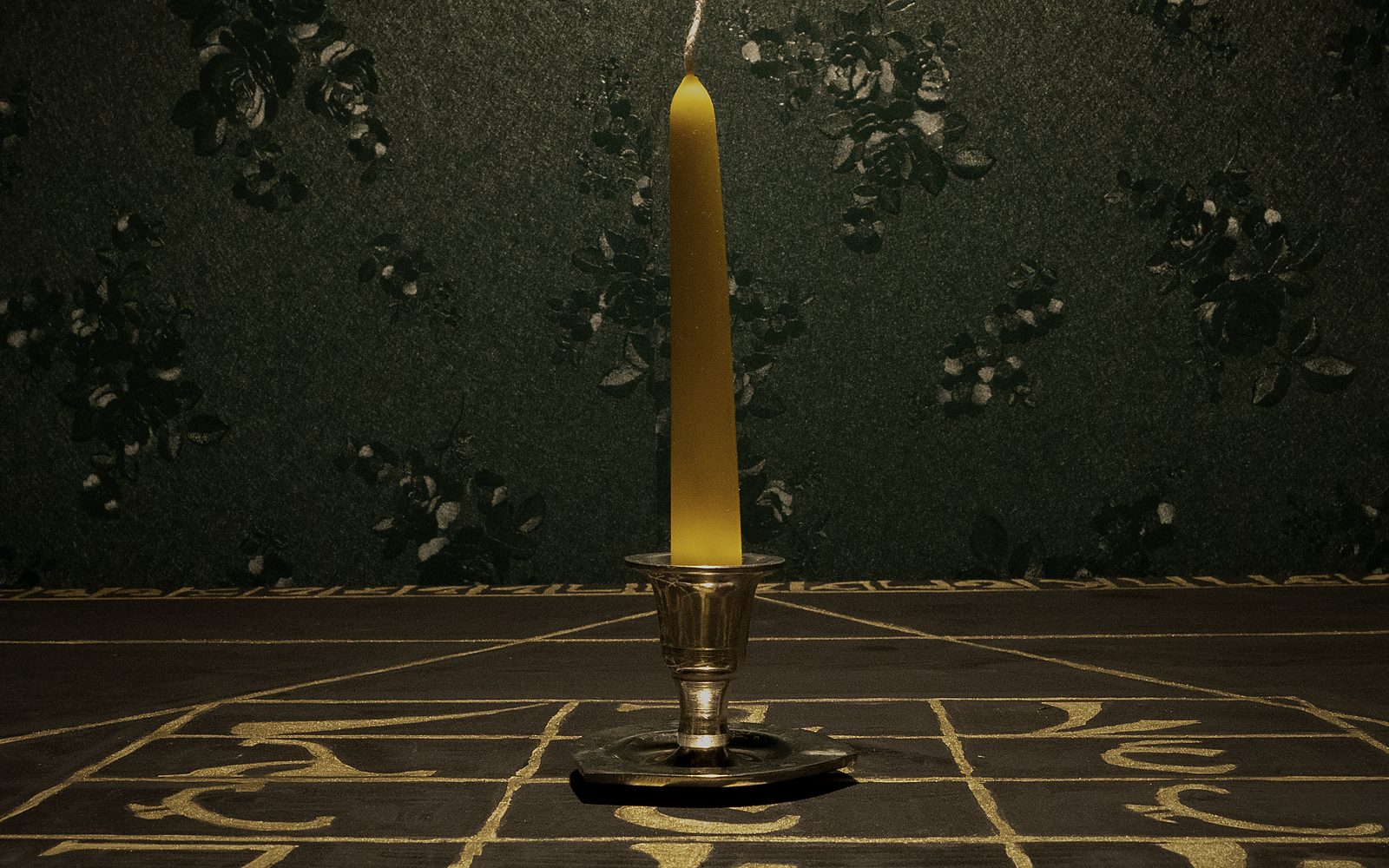 A hand-poured beeswax candle standing on the Holy Table, the silent witness of the operation
