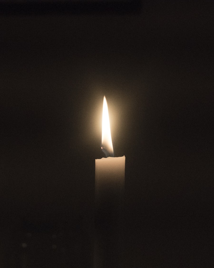A candle burning in the dusk of a ceremonial space