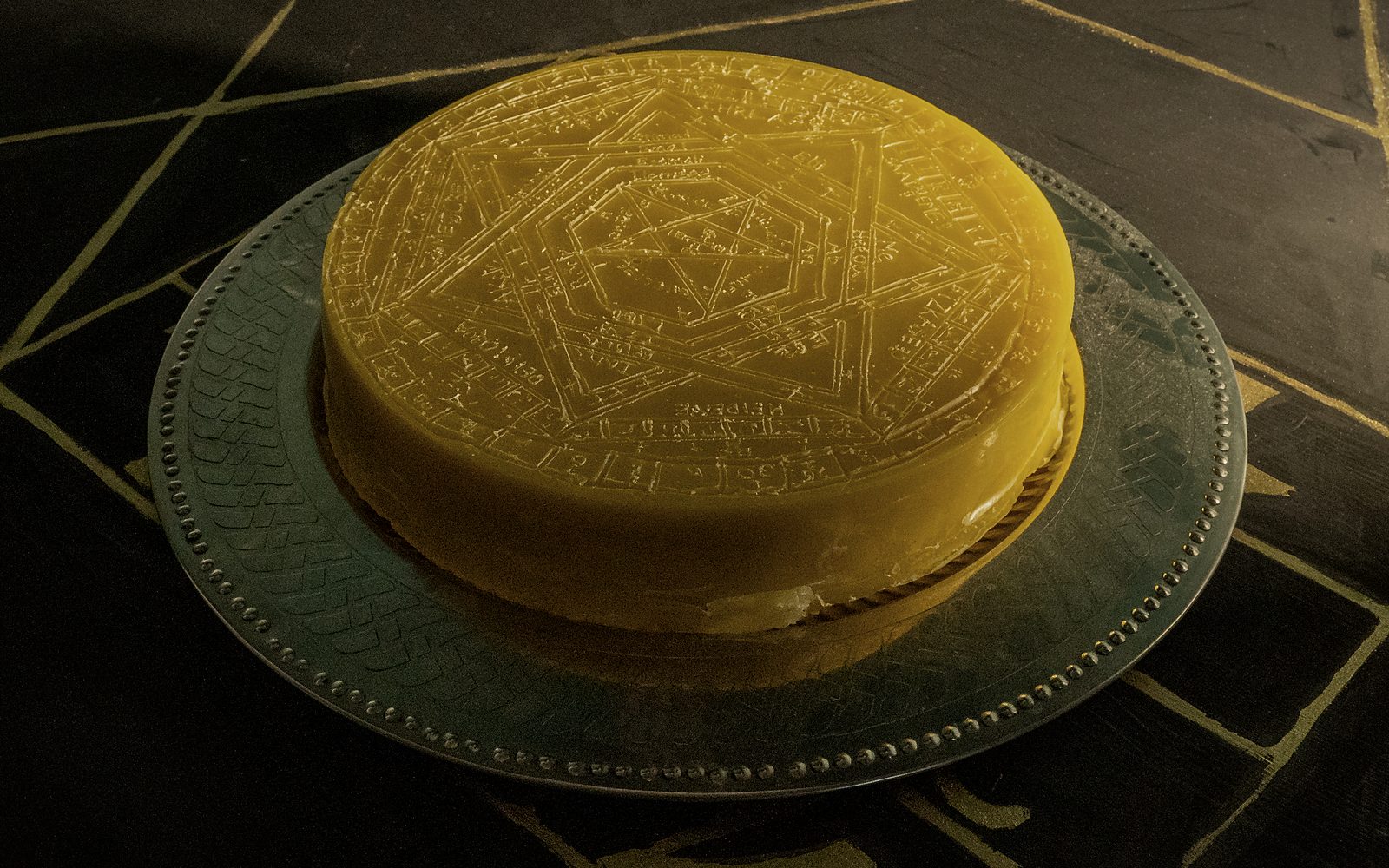 The Sigillum Dei Aemeth cast in beeswax, its heptarchic names and figures pressed into the surface