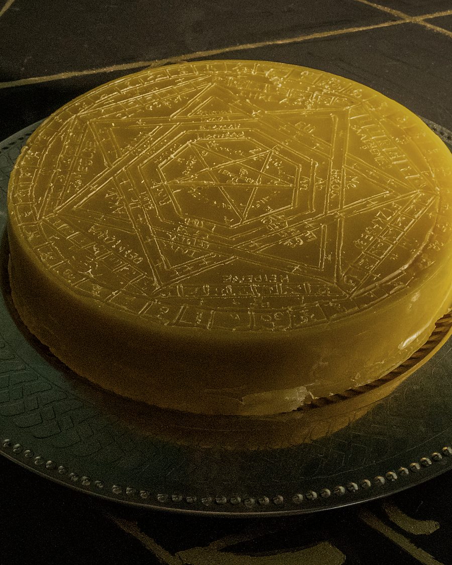 The Sigillum Dei Aemeth cast in beeswax, resting on a pewter plate
